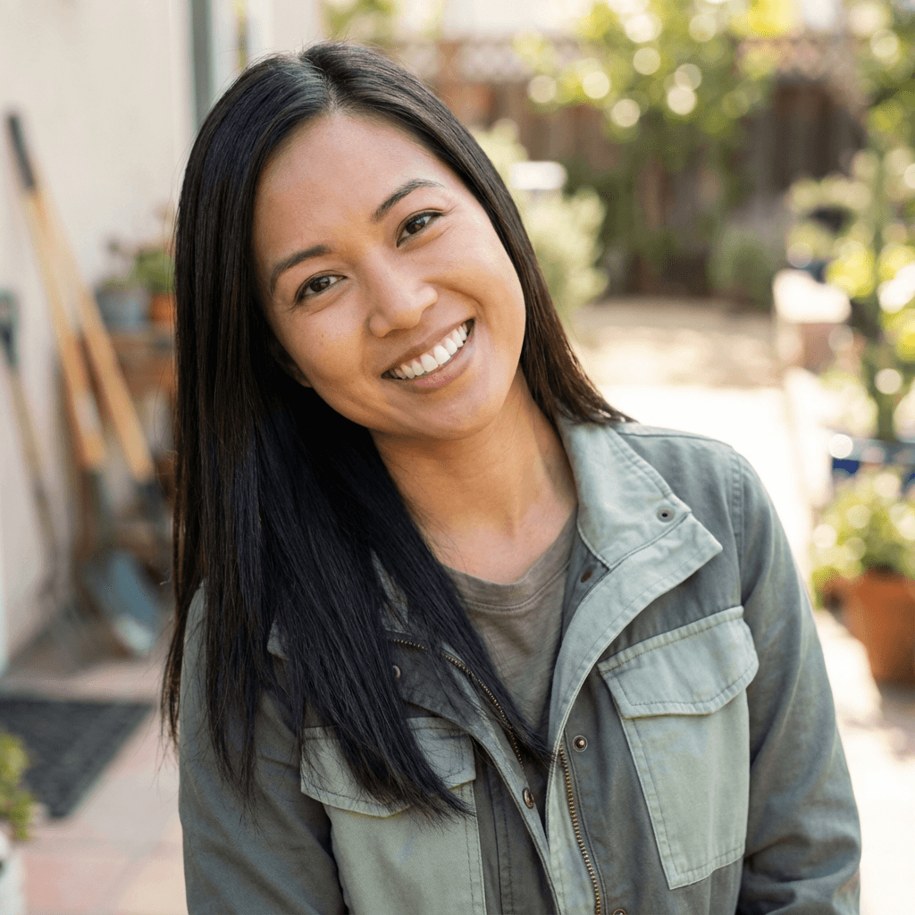 Female health coaching client in her late 20s with a thoughtful expression